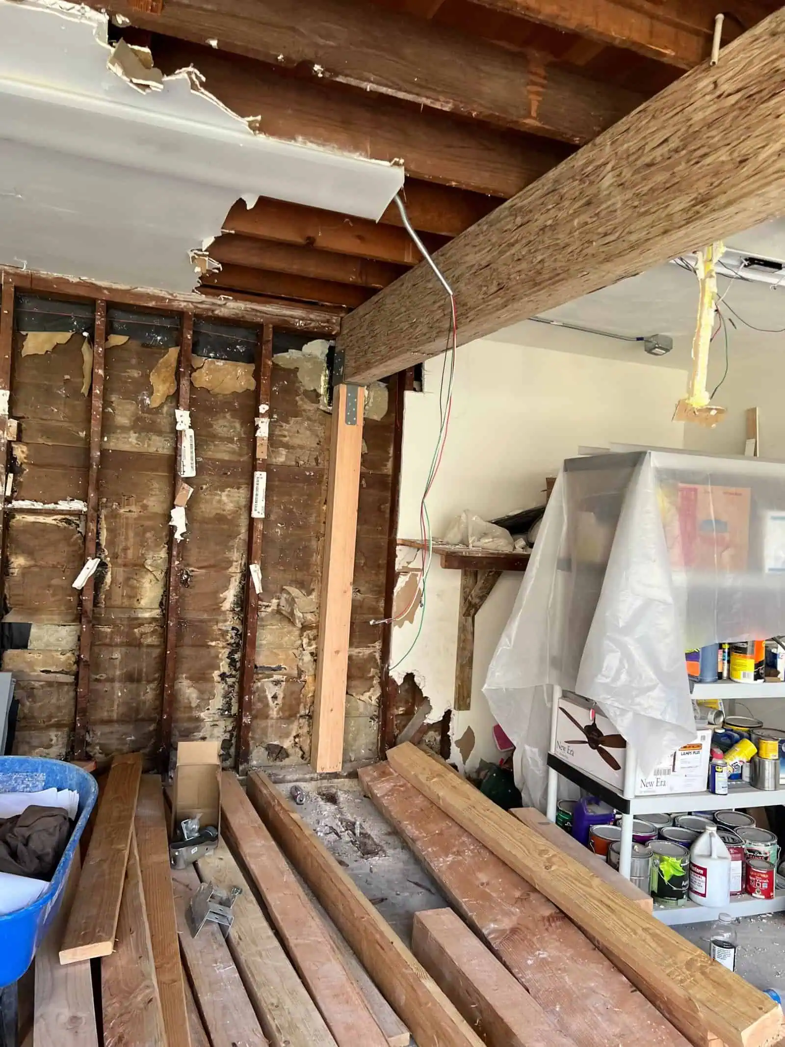 Interior of a renovation site with exposed beams and construction tools.