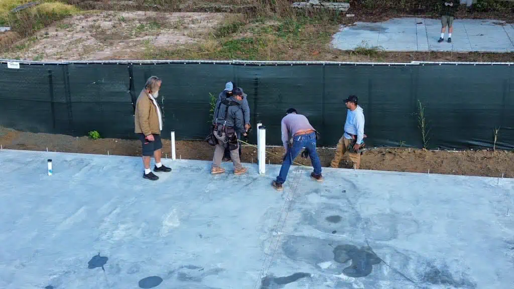 Construction workers preparing a foundation at a job site.